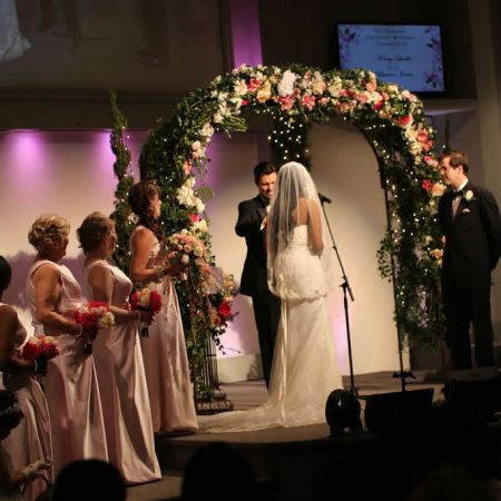 Ladd Covenant Wedding Spring Wedding Chuppah | White and Pink Rose Covered Arch with Greenery and Twinkle Lights