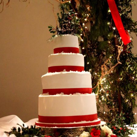 Ormaza/Elam Covenant Wedding Winter Wedding Cake | Four-Tiered White Wedding Cake with Red Ribbon and Powdered Sugar Snow