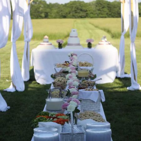 Outdoor Spring Wedding Reception Food Table | Pink and White Rose Centerpieces. White tablecloth