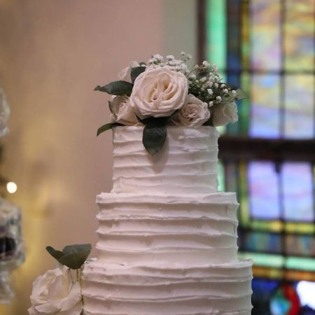White Four Tiered Wedding Cake with textured buttercream designs