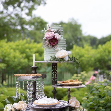 Remnant Fellowship Covenant Wedding Decorative White Wedding Cake with purple Floral Accents