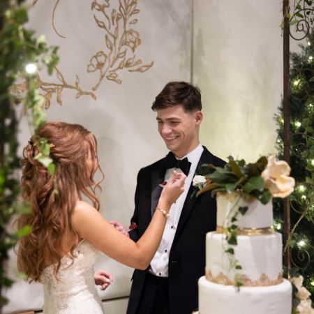 Mendl Hayden Covenant Wedding Mendl/Hayden Remnant Wedding Fall White tired Wedding cake with gold accents and magnolia greenery