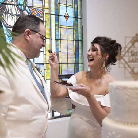 Young/Garcia Covenant Wedding Young/Garcia Remnant Wedding Cake Cutting White Detailed Tiered Wedding cake with pearl designs and textured buttercream designs and gold diamond monogrammed cake topper by the Remnant Fellowship Cake Committee