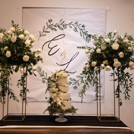 Kaunisto/Gormsen Covenant Wedding White Three tiered Wedding Cake with White roses and greenery by the Remnant Fellowship Cake Committee