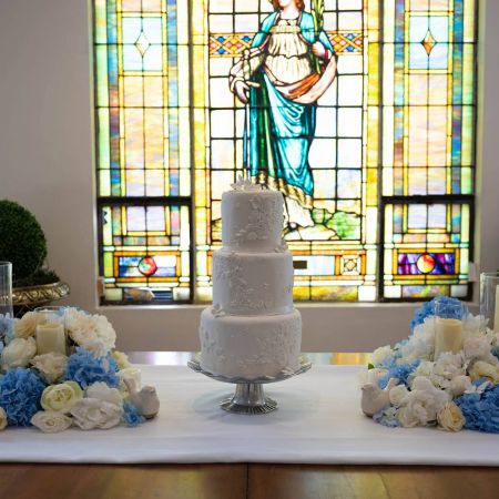 McPherson/Dunn Covenant Wedding White Three Tiered Wedding Cake with intricate buttercream designs for a Summer Wedding by the Remnant Fellowship Cake Committee