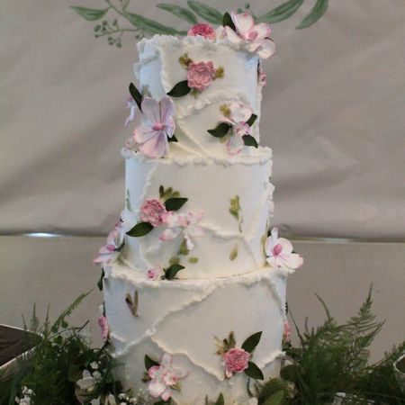 White Tiered Wedding cake with pink flower details and frosting designs by Remnant Fellowship Cake Committee
