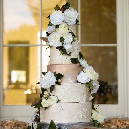 Mendl/Radebagh Covenant Wedding White and Ivory Wedding Cake with gold details and white flowers
