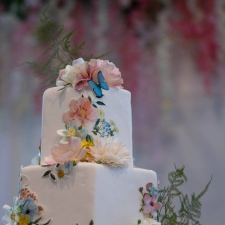 Smith/Wheeler Covenant Wedding Smith/Wheeler Remnant Wedding White Square Tiered Wedding Cake with cascading pastel florals by the Remnant Wedding Cake Committee