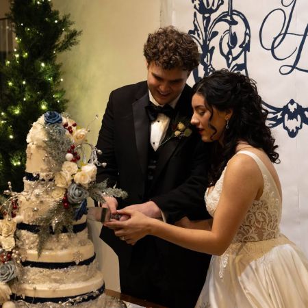 Smith/Wright Covenant Wedding Smith/Wright Remnant Fellowship Wedding Cake Cutting- Winter Wedding Cake with Blue, White and Deep red floral accents by the Remnant Fellowship Cake Committee