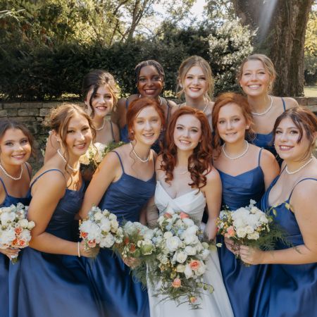 Weaver/Purdy Covenant Wedding summer blue tea-length bridesmaid dresses with white, blue, and coral bouquets