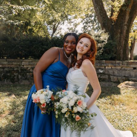 WeaverPurdy Covenant Wedding Bridesmaids in a blue summer tea-length dress, with white coral and light blue bouquets