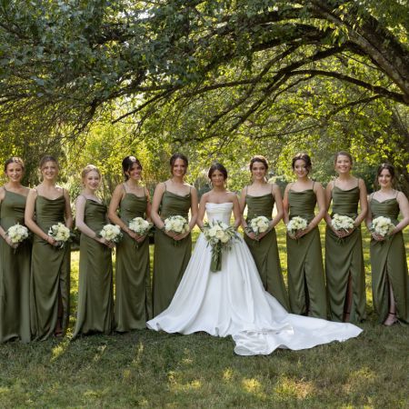 A group of Bridesmaids wearing martini green silk bridesmaids dresses for a fall remnant fellowship covenant wedding