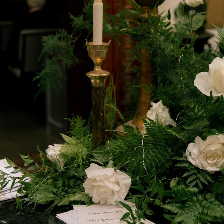 Indoor Table Decorations, Gold candle sticks with white roses and green foliage decorated by our Remnant Fellowship Decorating Team