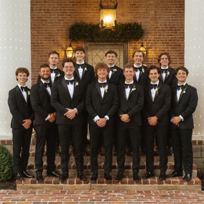 Groomsmen with Classy black Tuxes and oversized bow tie