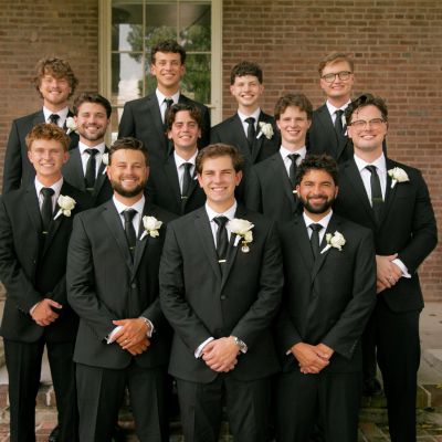 Groomsmen Party with Black Suits and White Rose buttoners for a Remnant Fellowship Wedding