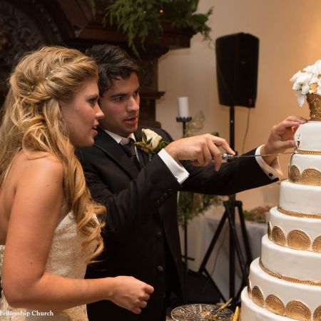 Jost/Martin Covenant Wedding Bride and Groom Cutting of the Cake | Golden Accented Tiered Wedding Cake